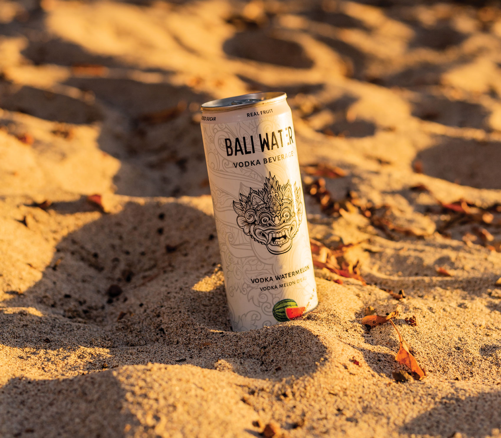 Can of Bali Water Vodka Beverage sitting in the sand