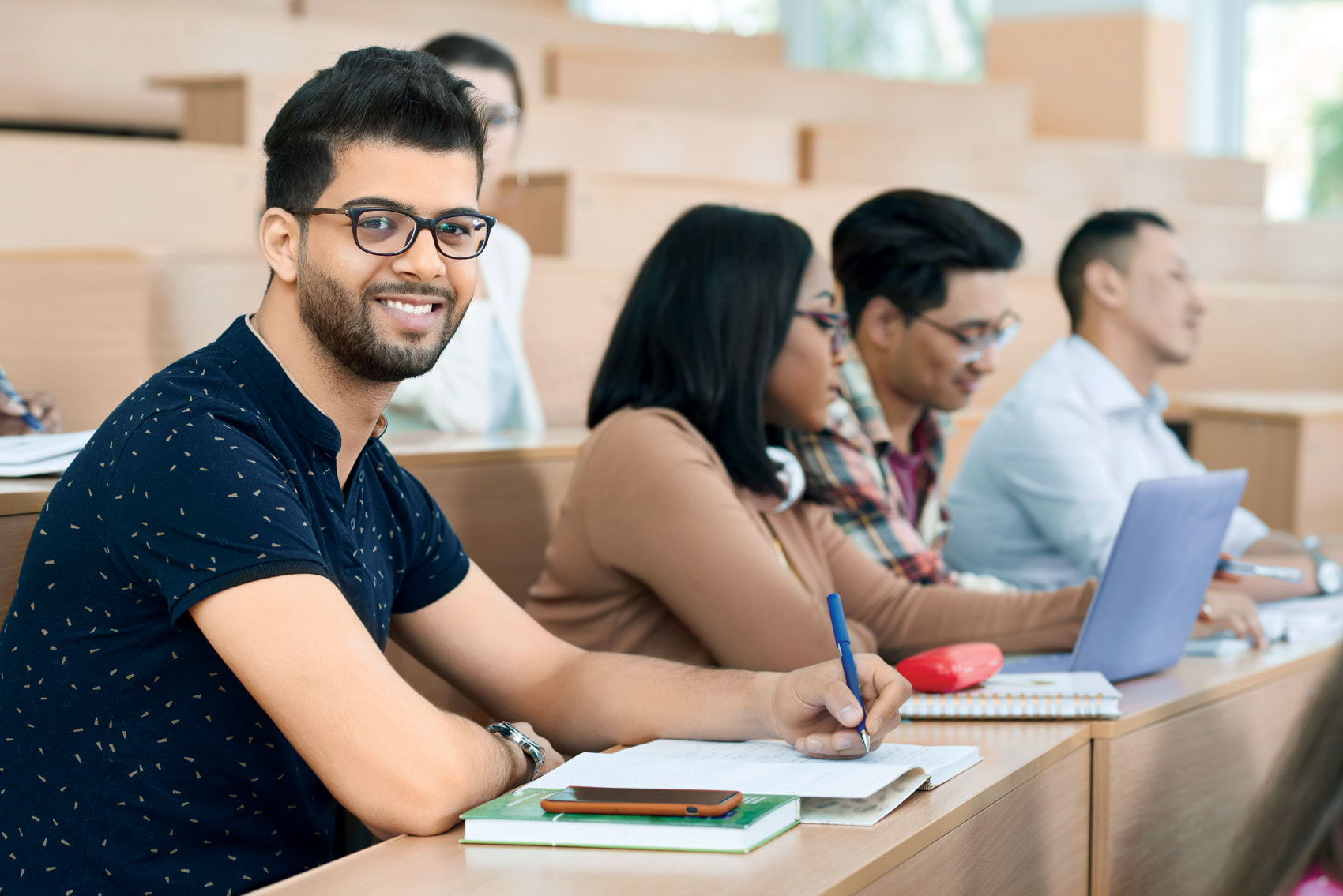 Man smiling for photo in classroom