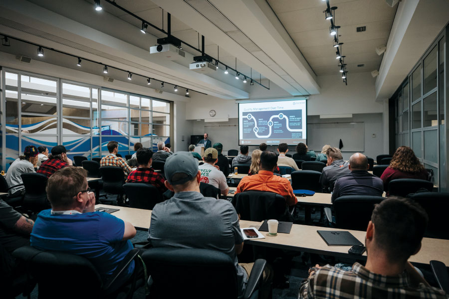 Attendees looking at slide on projector