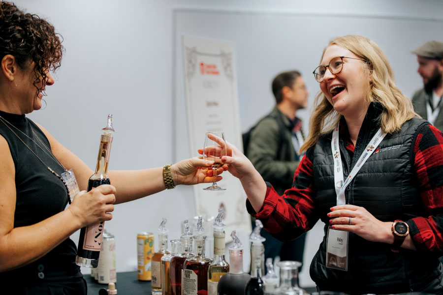 Vendor giving sample to smiling attendee