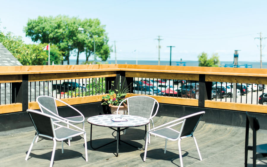 Table and chairs on patio with lake in background