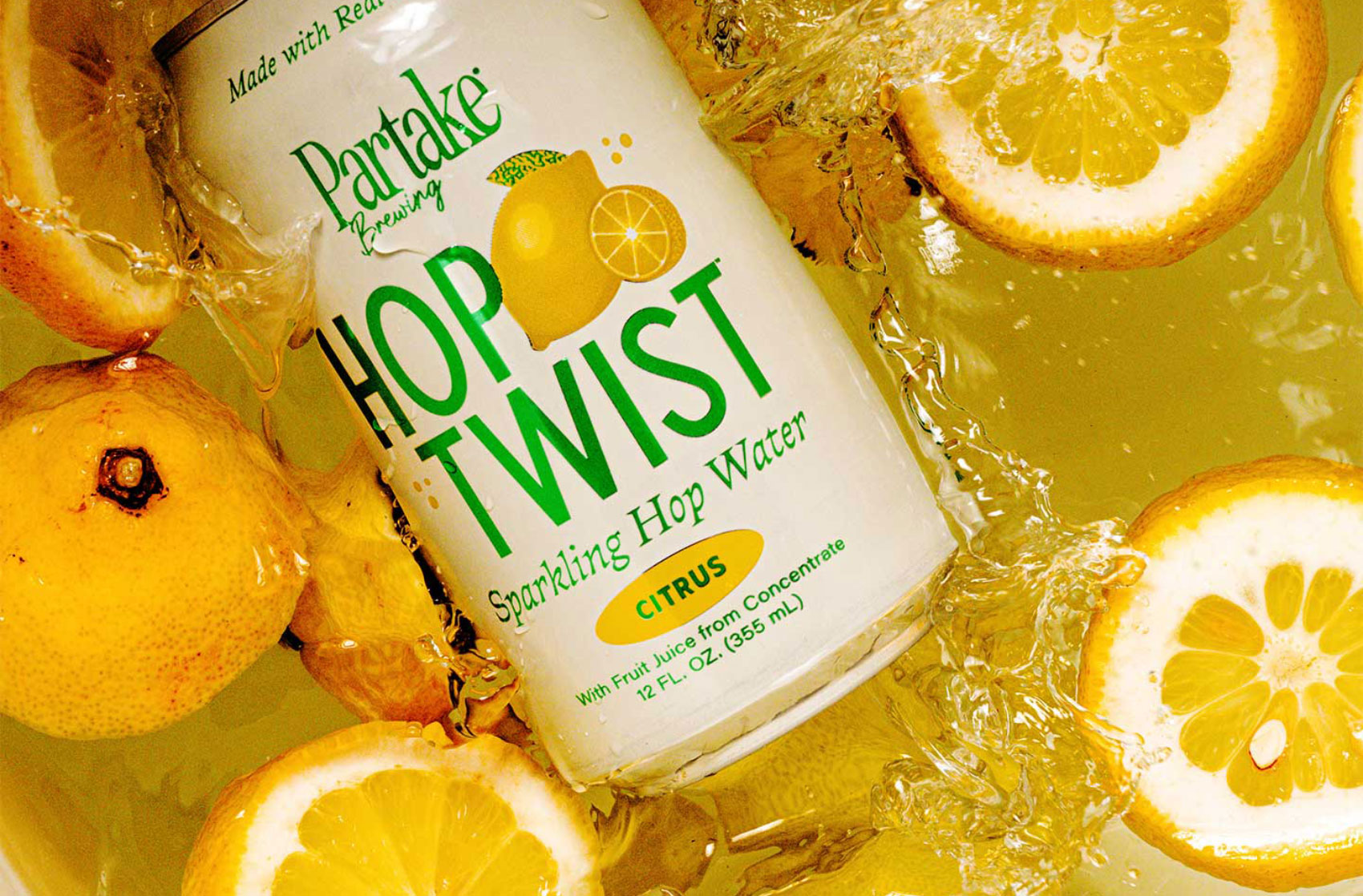 Can of Hop Twist floating in water and lemon slices