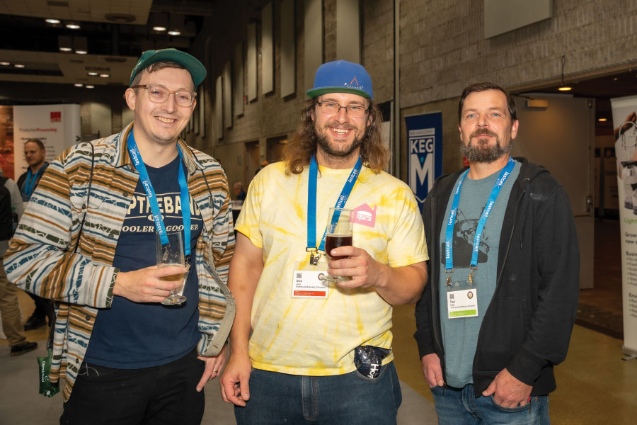 Three attendees smiling for group photo